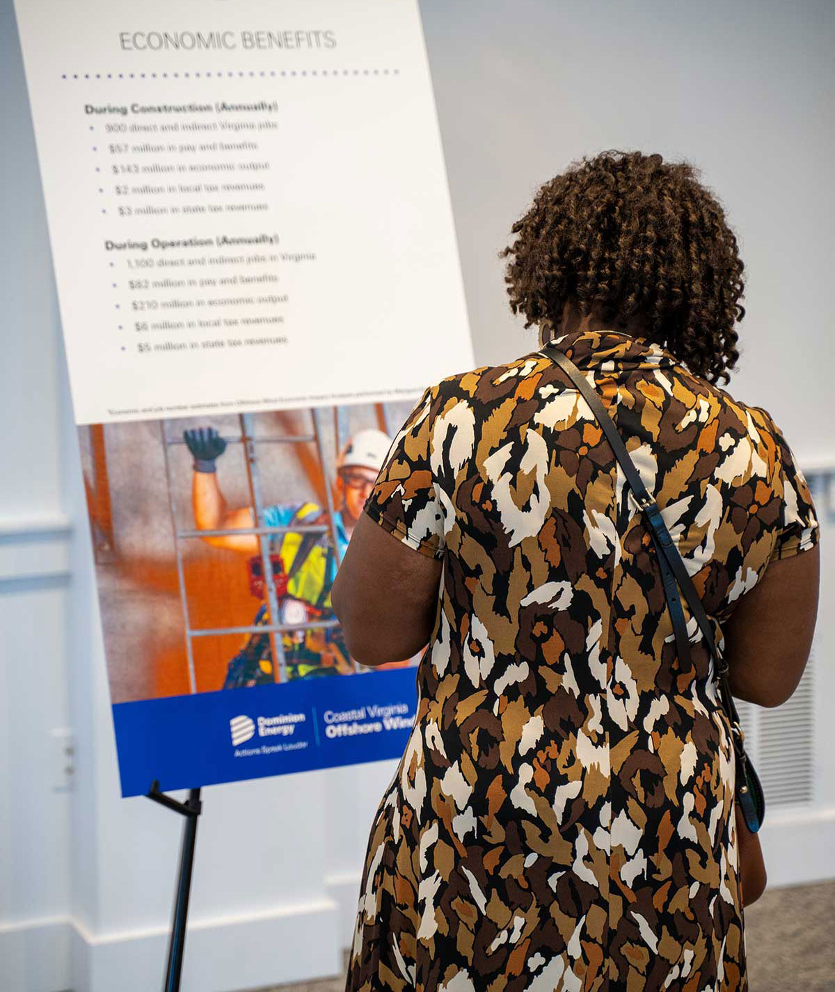 Woman reviewing boards at community engagement meeting